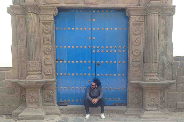 J sat in doorway in Peru
