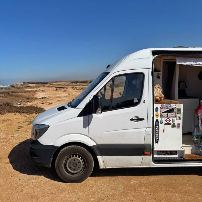 View of front of van Parkes up on sand
